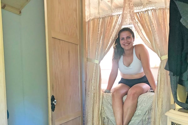 woman sitting in the bed of a gypsy caravan