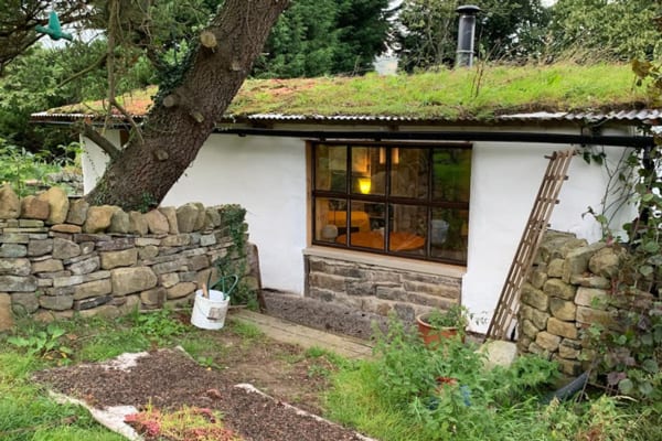 earth home peak district view of the side and roof with a window