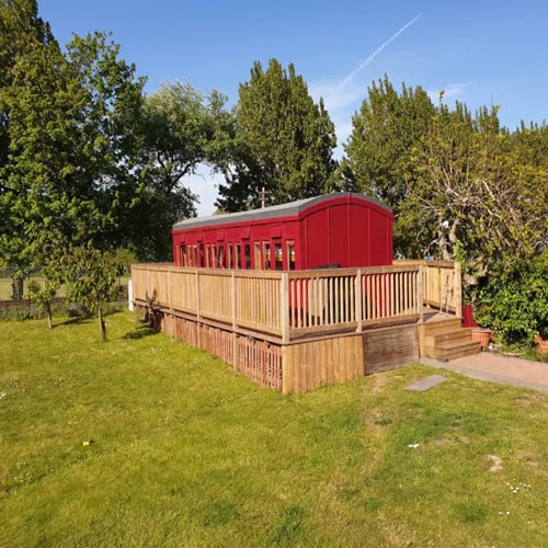 outside view of glamping train carriage in new forest