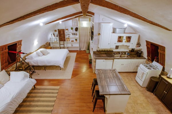 Moon Camp: an off-Grid Joshua Tree Glamping Retreat view of inside with bed, kitchen and couch