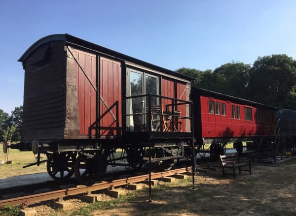 1880's red Railway Carriage in Essex view of the back of carriage with a small balcony