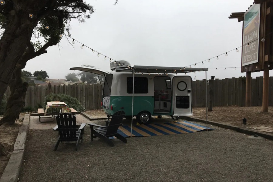 Happy camper for glamping in Big Sur view of outside of camper and picnic area