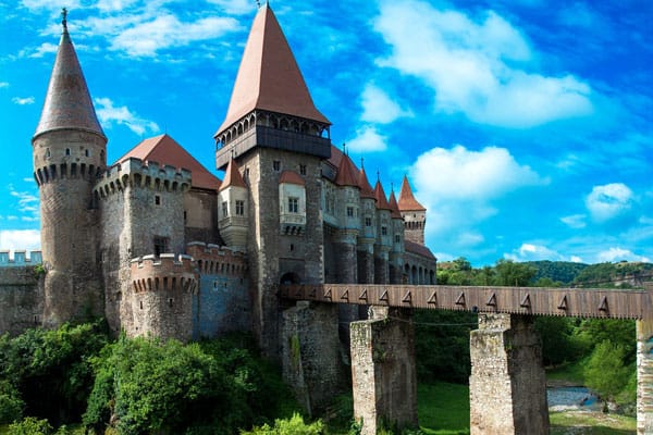 view of corvin castle romania, bridge and castle walls and turrets