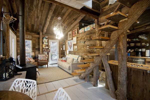 Sugar Creek Treehouse Asheville NC view from inside with couch, stove and staircase to loft