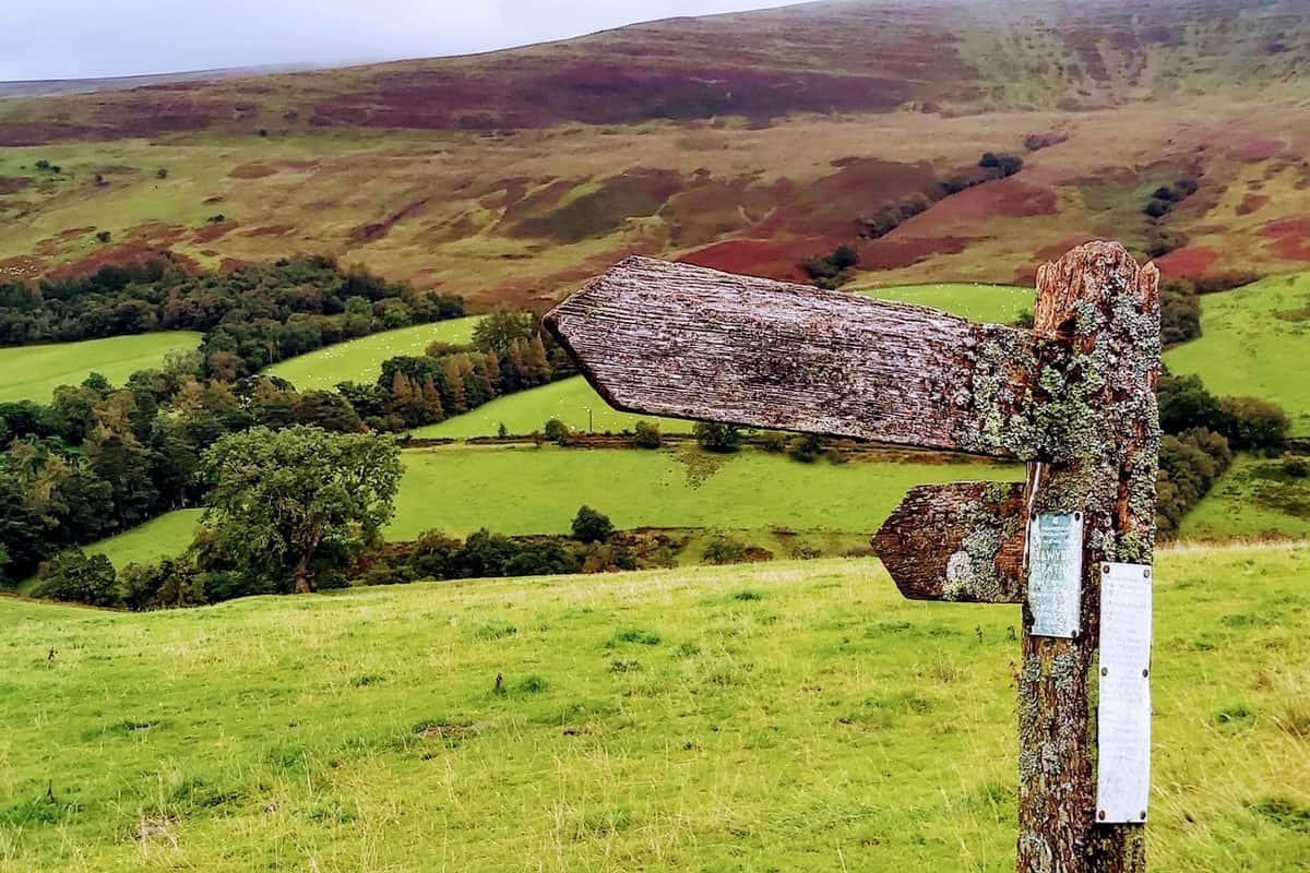 Glamping in Brecon Beacons Wales sign with view of green countryside