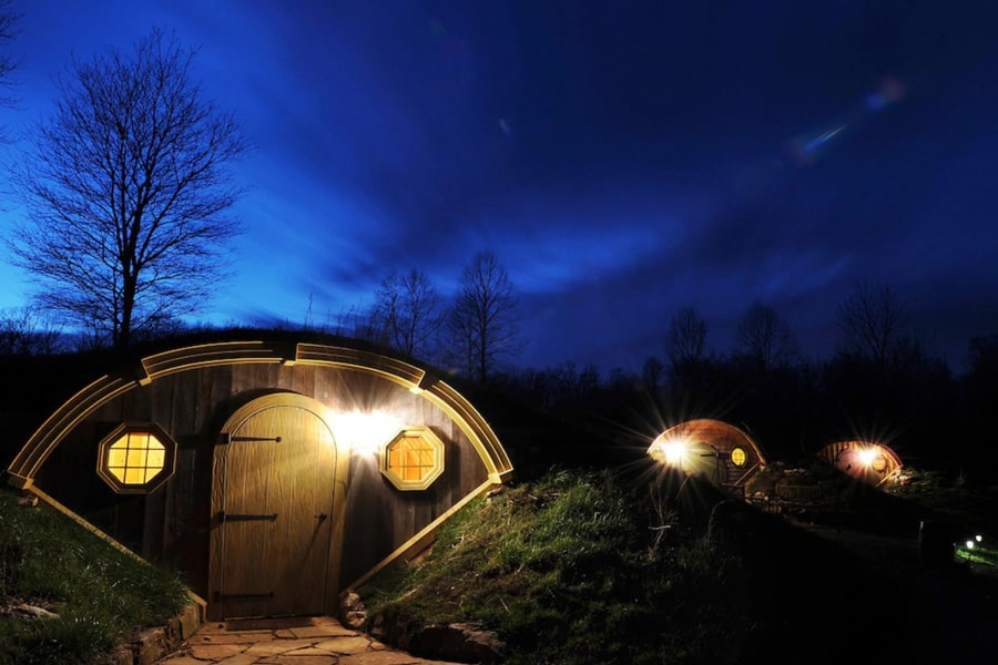 Forest Gully Farms Hobbit Homes view of the hobbit holes at night with lights on